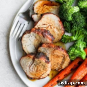 Grilled pork tenderloin served with vegetables.
