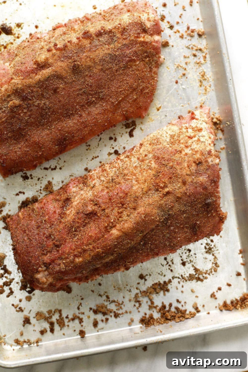 Dry rubbed sous vide ribs on a baking sheet.