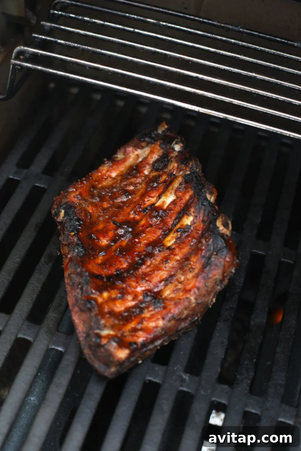 Sous vide ribs caramelizing on the grill, showing the delicious crust forming.