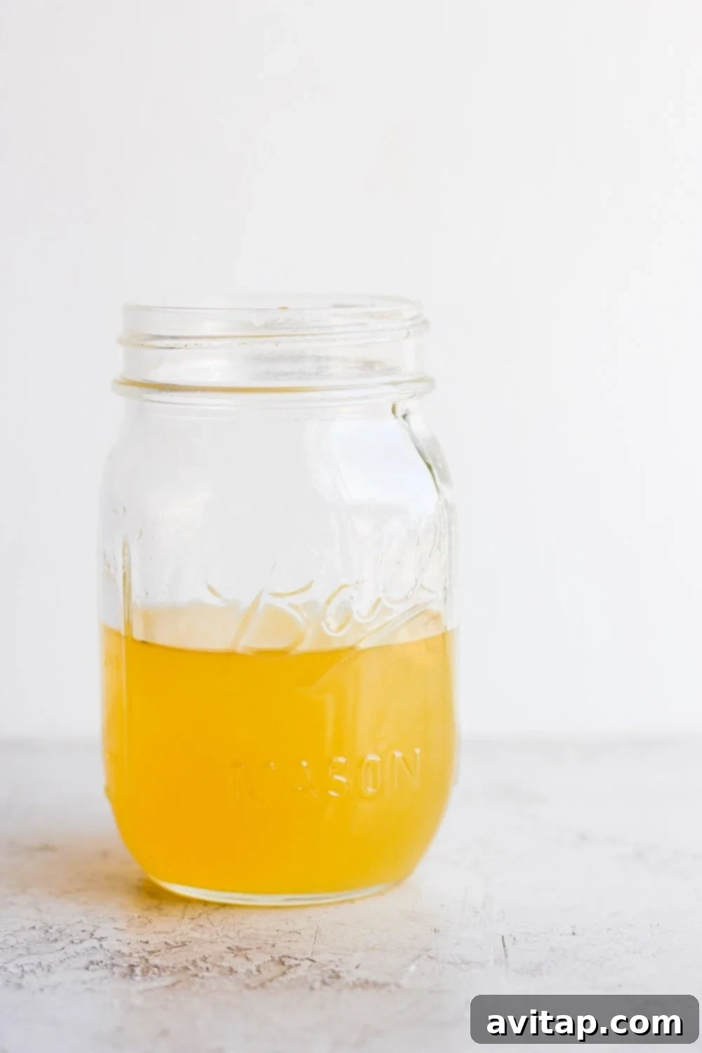 Vinegar Brine for Quick Pickled Onions Clear mason jar filled with pickling vinegar solution