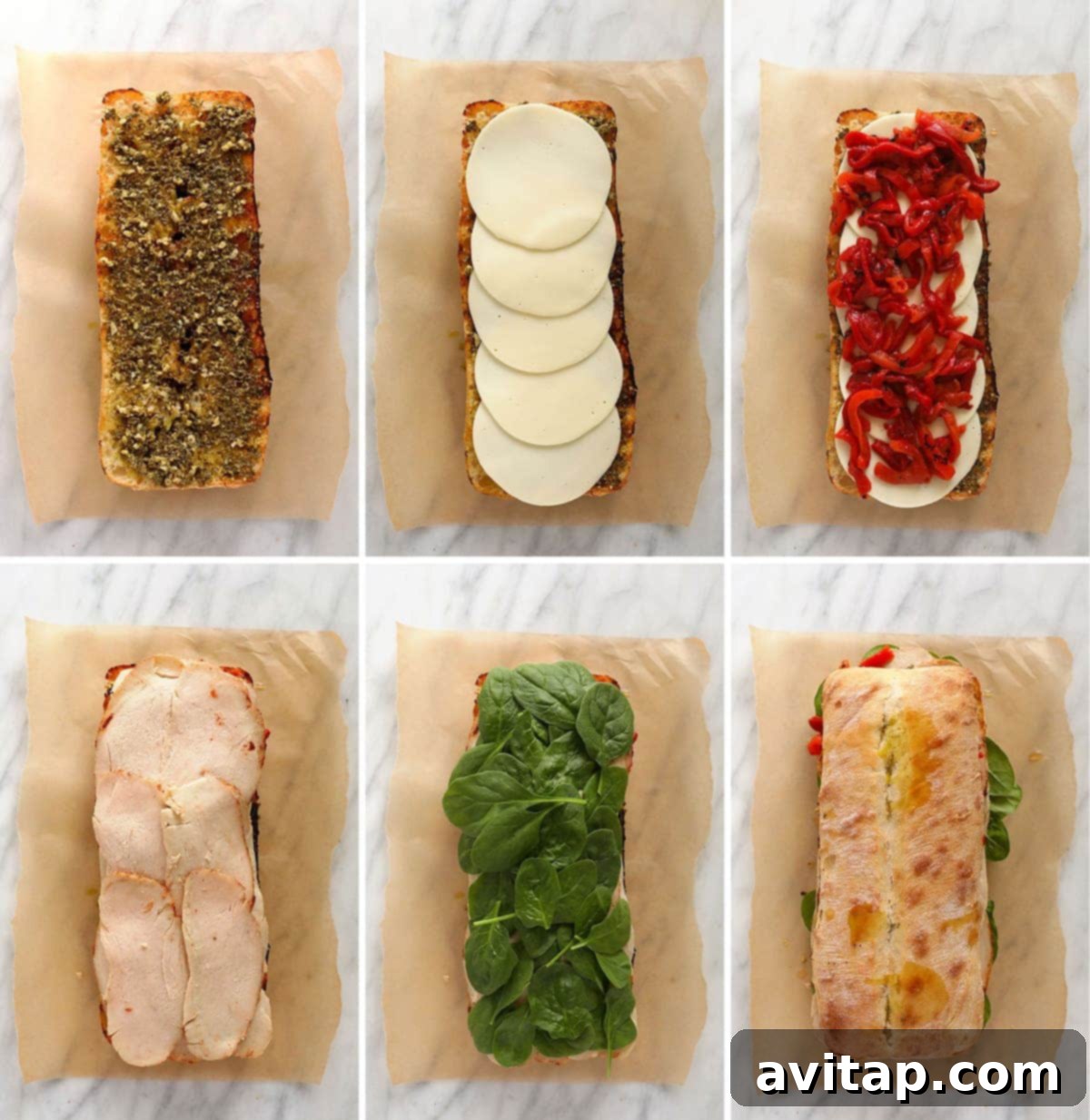 Layering all the ingredients for the grilled turkey pesto sandwich on the bread, showing the rich pesto, turkey, cheese, and roasted red peppers