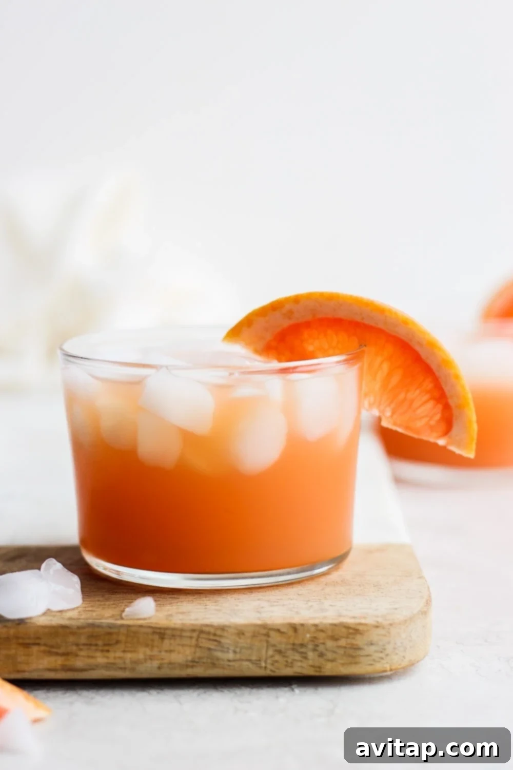 A perfectly prepared Paloma cocktail, chilled with ice and garnished with a grapefruit slice, ready to be served