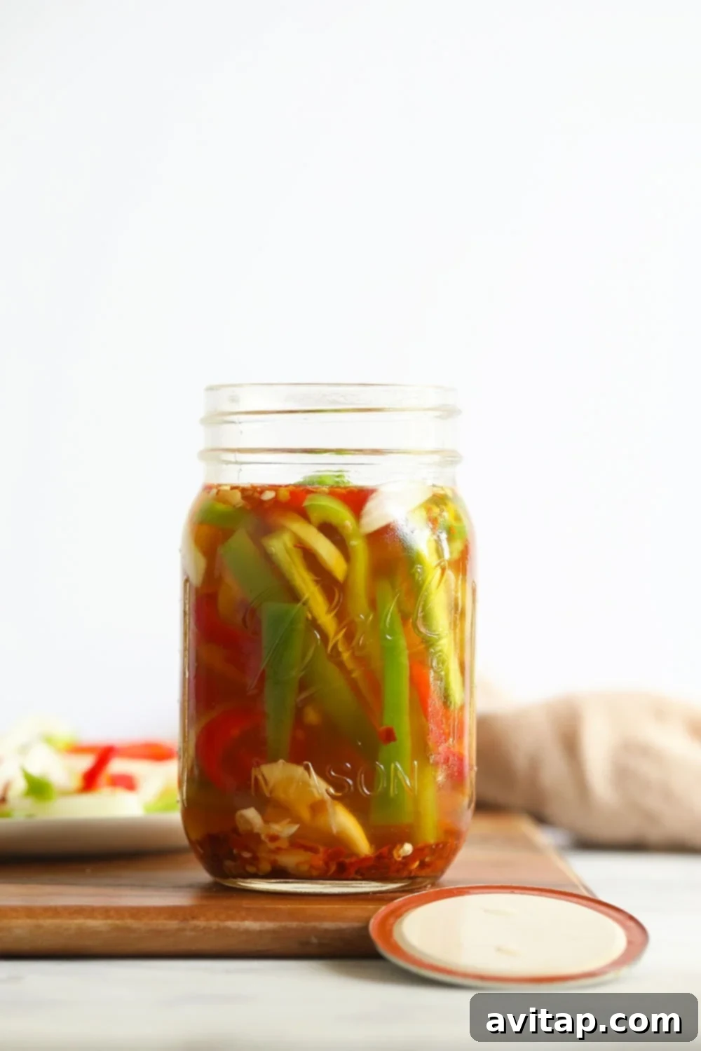 A jar filled with bright, quick pickled spicy peppers, ready to be enjoyed.