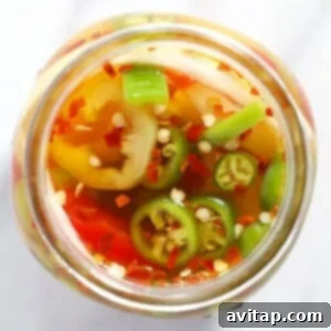A jar with quick pickled spicy peppers.
