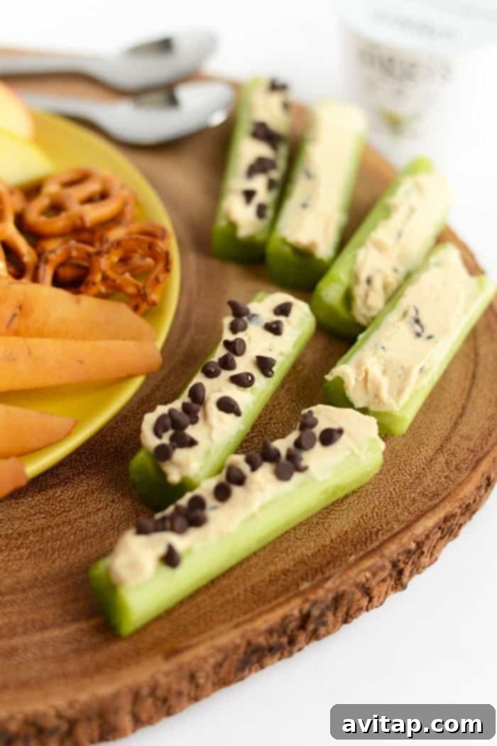 Peanut butter Greek yogurt dip spread into celery slices for a healthy snack