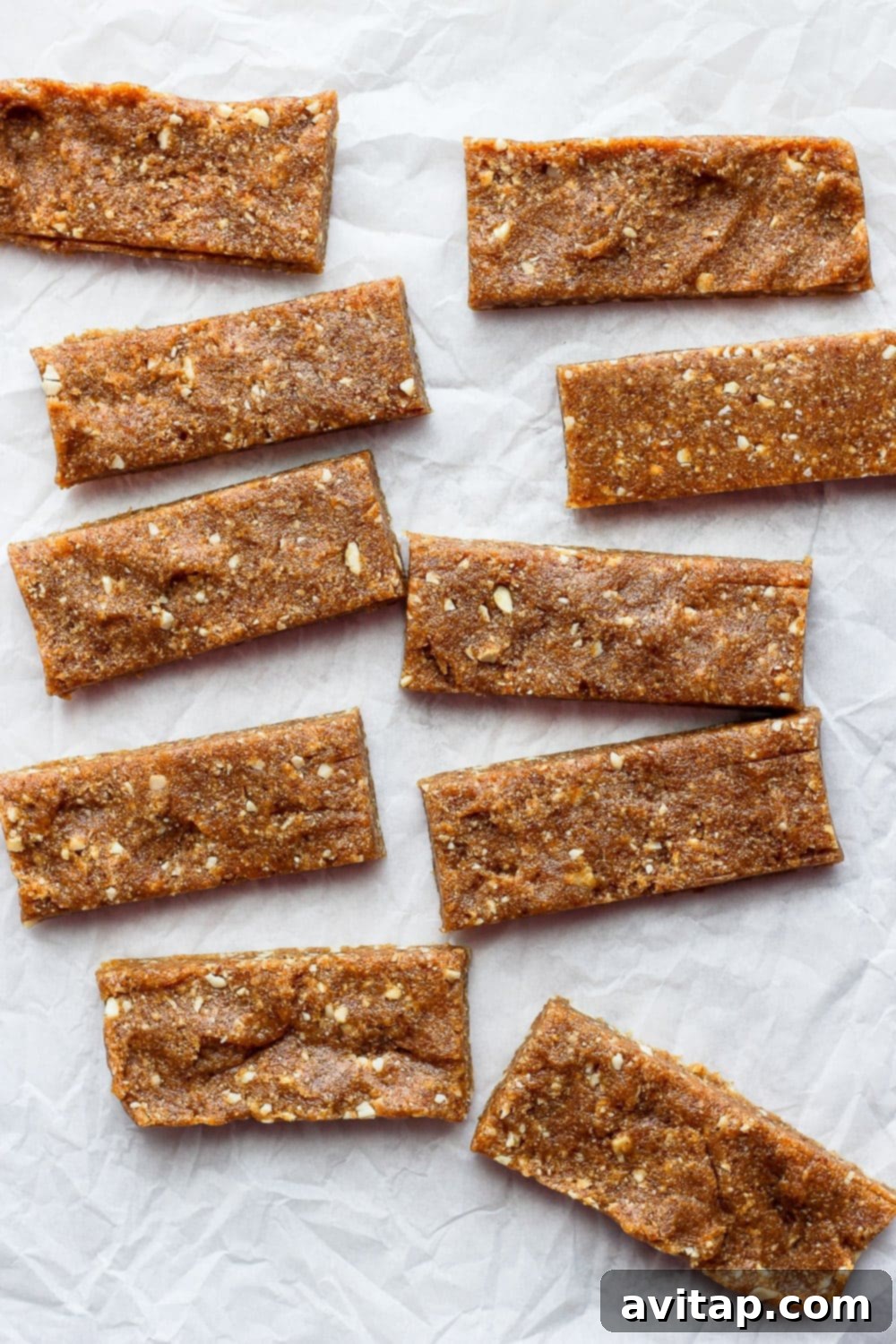 Delicious Homemade Cashew Date Bars for Healthy Snacking Stacked homemade Copycat Cashew Cookie Larabars on parchment paper, ready for healthy snacking.