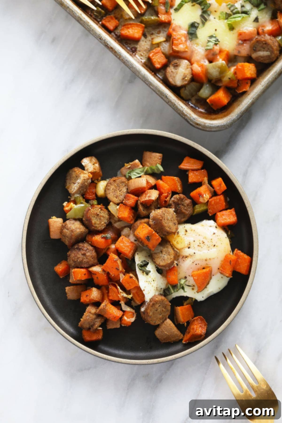 A single serving of sweet potato hash with a perfectly baked egg on a white plate, ready to enjoy.