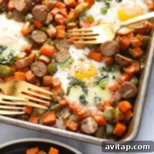 sweet potato hash with eggs on sheet pan with forks