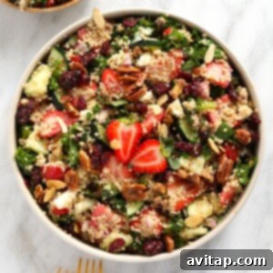 Vibrant Strawberry Quinoa Salad 6 A bowl of quinoa salad with strawberries and nuts.