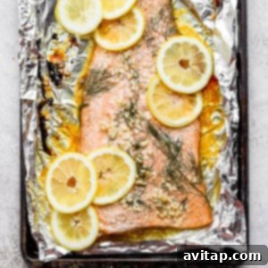 Baked salmon in a baking sheet, showcasing its golden-brown crust and flaky texture.
