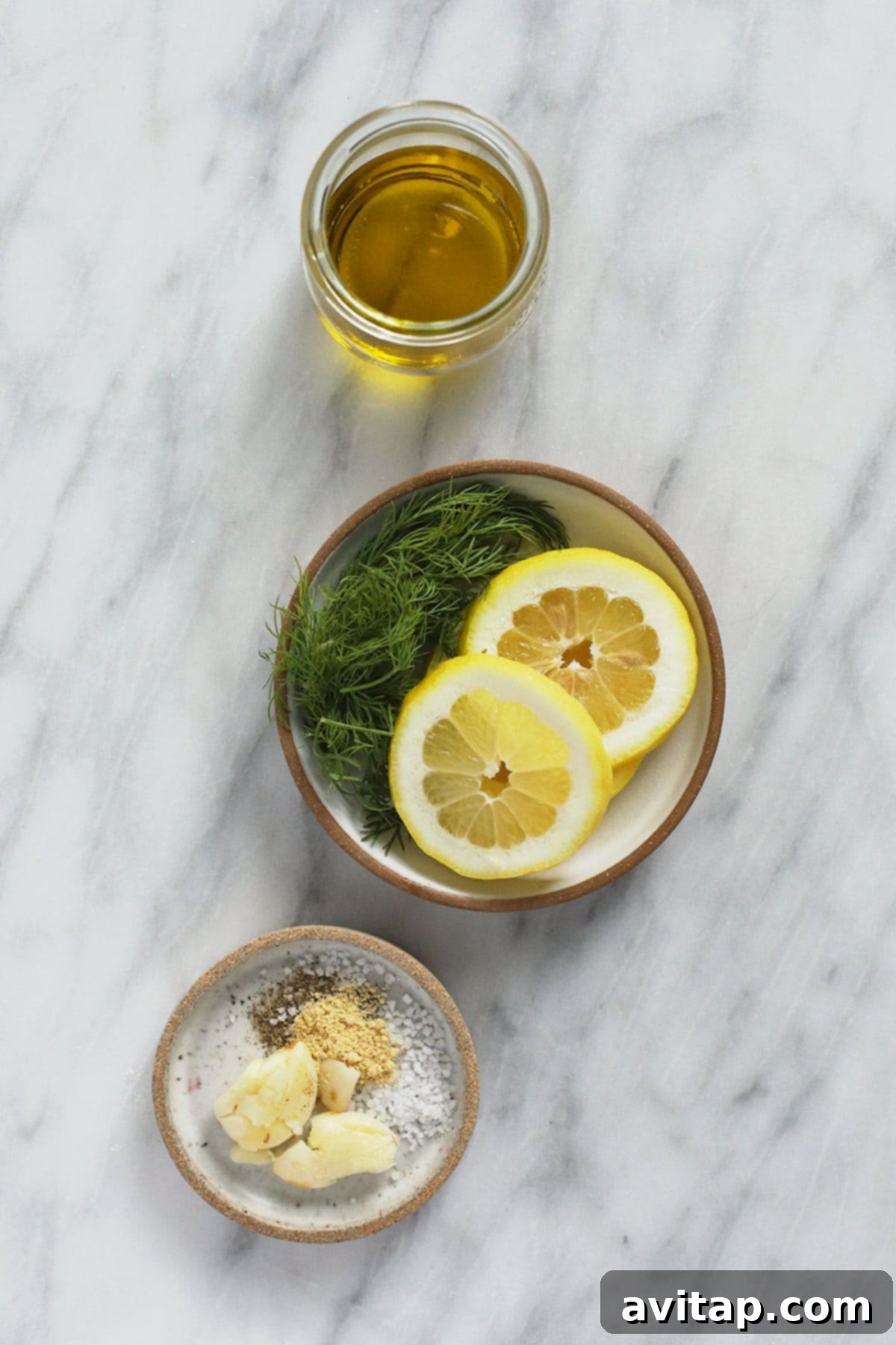 Fresh ingredients are key to a vibrant lemon chicken marinade. Close-up of fresh ingredients for a lemon chicken marinade: lemon, garlic, olive oil, and herbs.