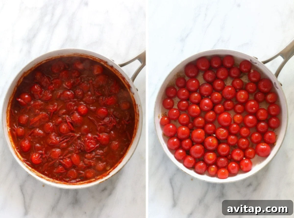 A close-up view of cherry tomatoes simmering in a skillet with olive oil and garlic, beginning to break down into a sauce.
