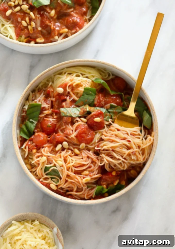A top-down view of the garden summer pasta in a bowl, showcasing the rich tomato sauce, fresh basil, and perfectly cooked pasta.