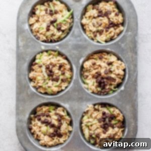 Oatmeal muffin batter portioned into a muffin tin.
