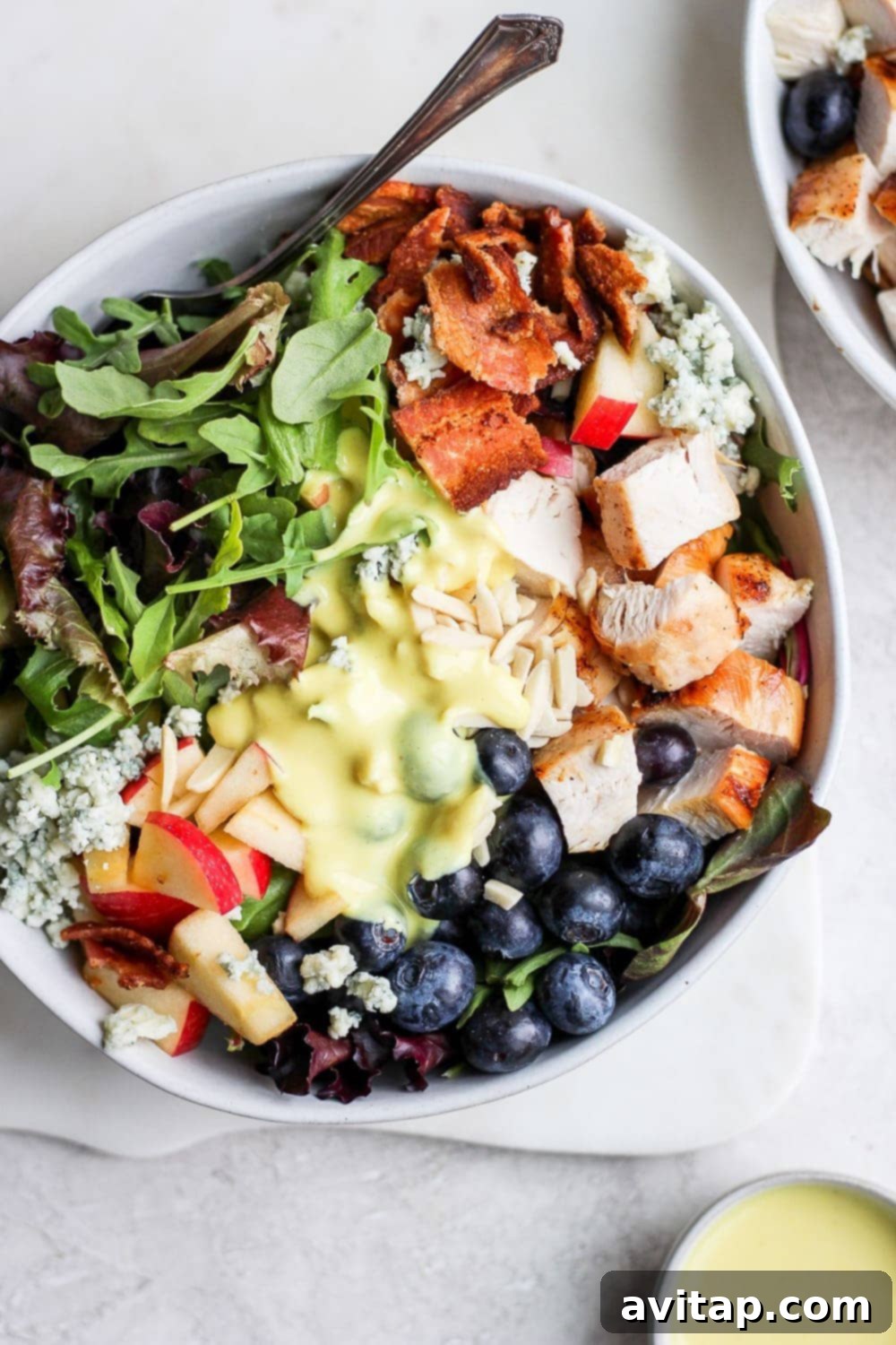 Chargrilled Chicken Garden Salad 2 Grilled chicken salad in a bowl with a small cup of dressing. The most delicious grilled chicken salad on the internet! This recipe has a homemade honey mustard dressing, perfectly grilled chicken, and tons of fresh toppings!