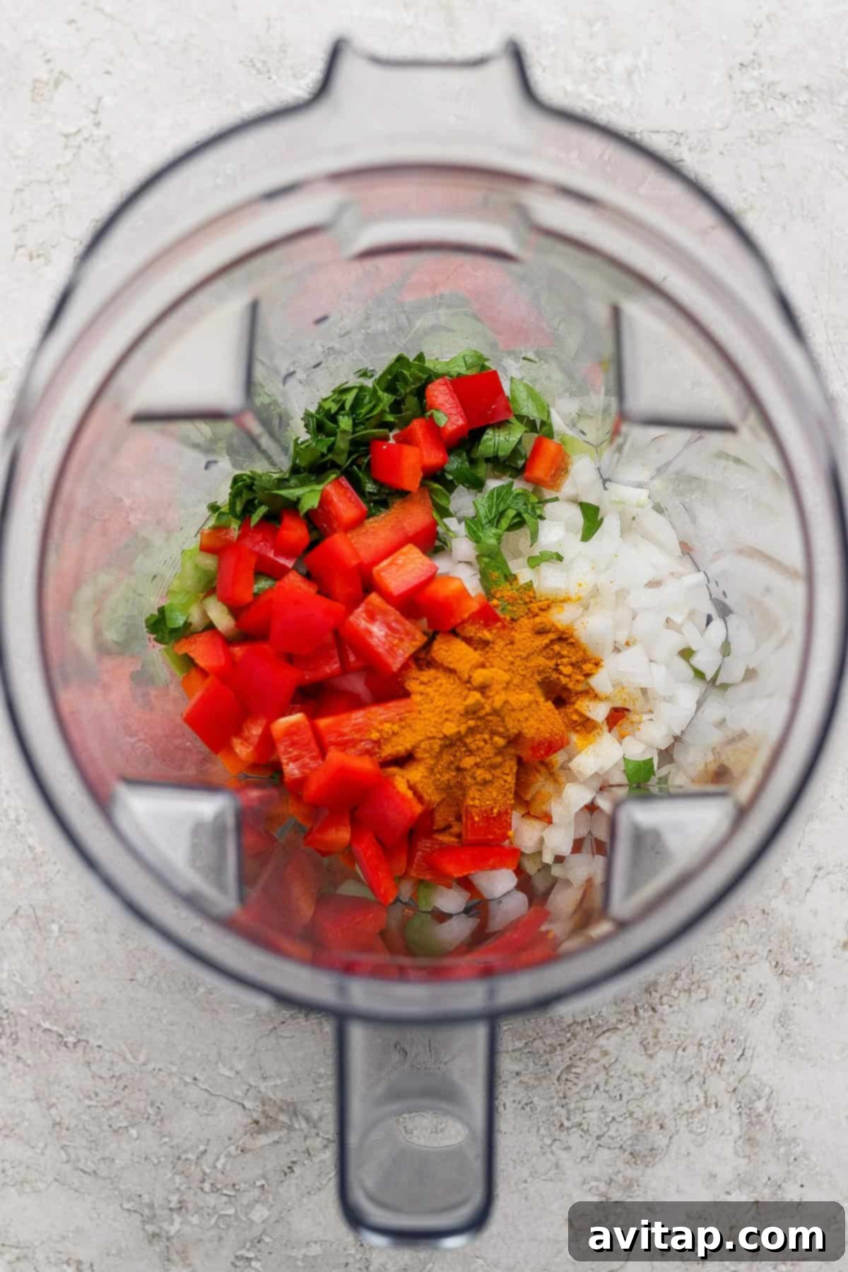 A blender filled with colorful vegetables and spices for the immunity paste.