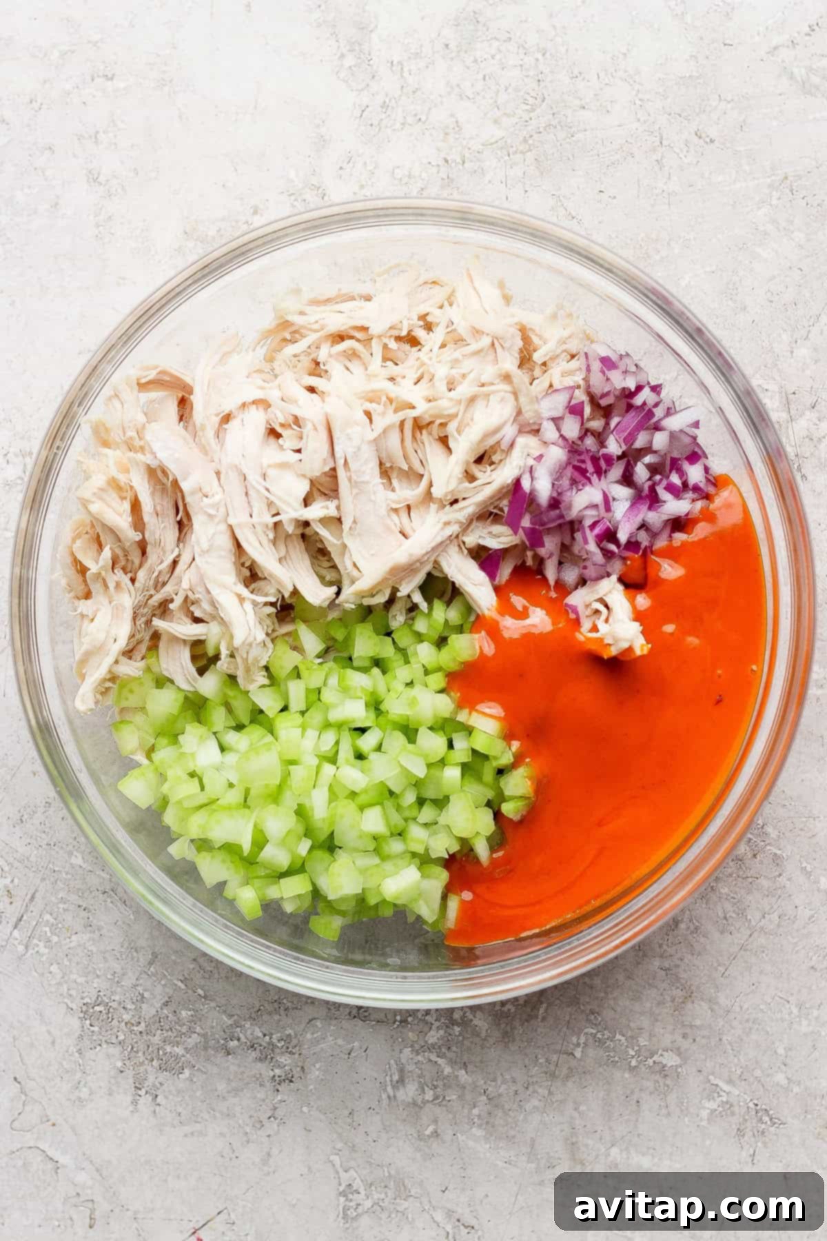 Ingredients for Buffalo Chicken Tacos - Shredded chicken, celery, red onion, and buffalo sauce.