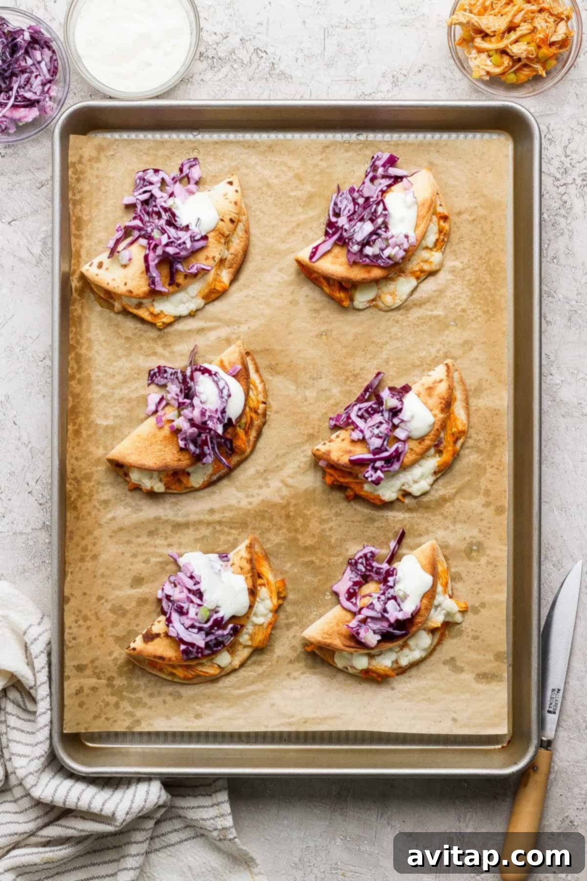 Baked Buffalo Chicken Tacos on a Sheet Pan - Crispy tacos filled with buffalo chicken and slaw.