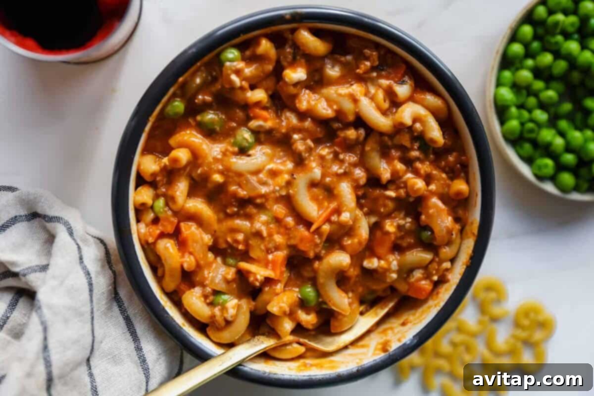 Cottage Cheese Boost: Hamburger Helper Upgrade 2 A comforting bowl of Cottage Cheese Hamburger Helper with macaroni, ground beef, vegetables, and a creamy tomato-based sauce.