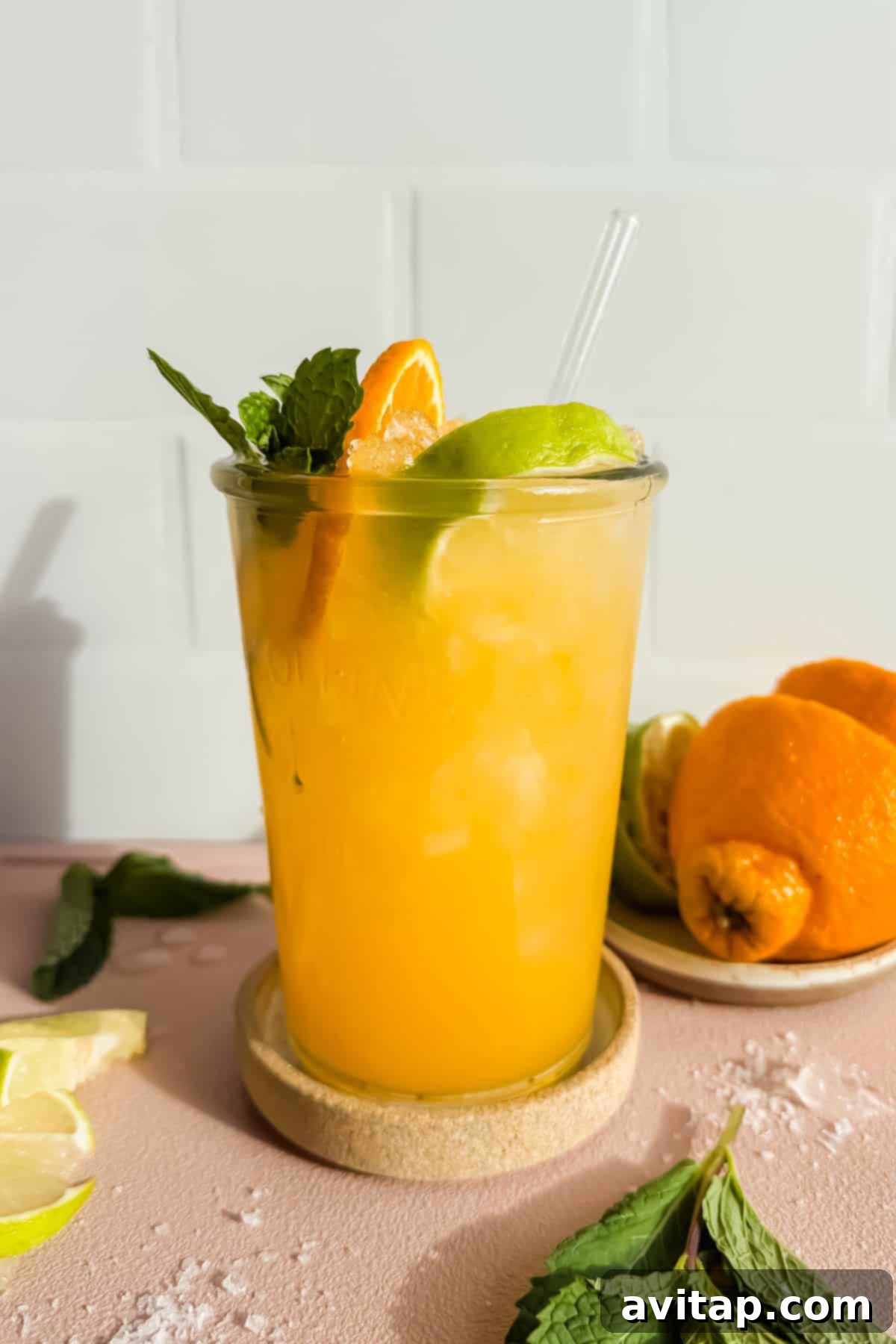 Coconut Citrus: Nature's Energy Boost 2 A refreshing glass of Nature's Gatorade with lime, orange, and mint garnish.