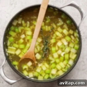 Adding vegetables to the pot.