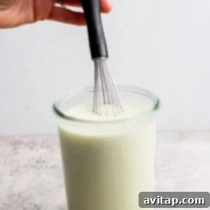 Tempering the cottage cheese with broth.
