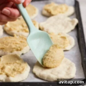 Spreading filling on dough rounds