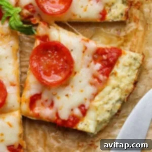 A square slice of pepperoni chicken crust pizza with melted cheese and tomato sauce.