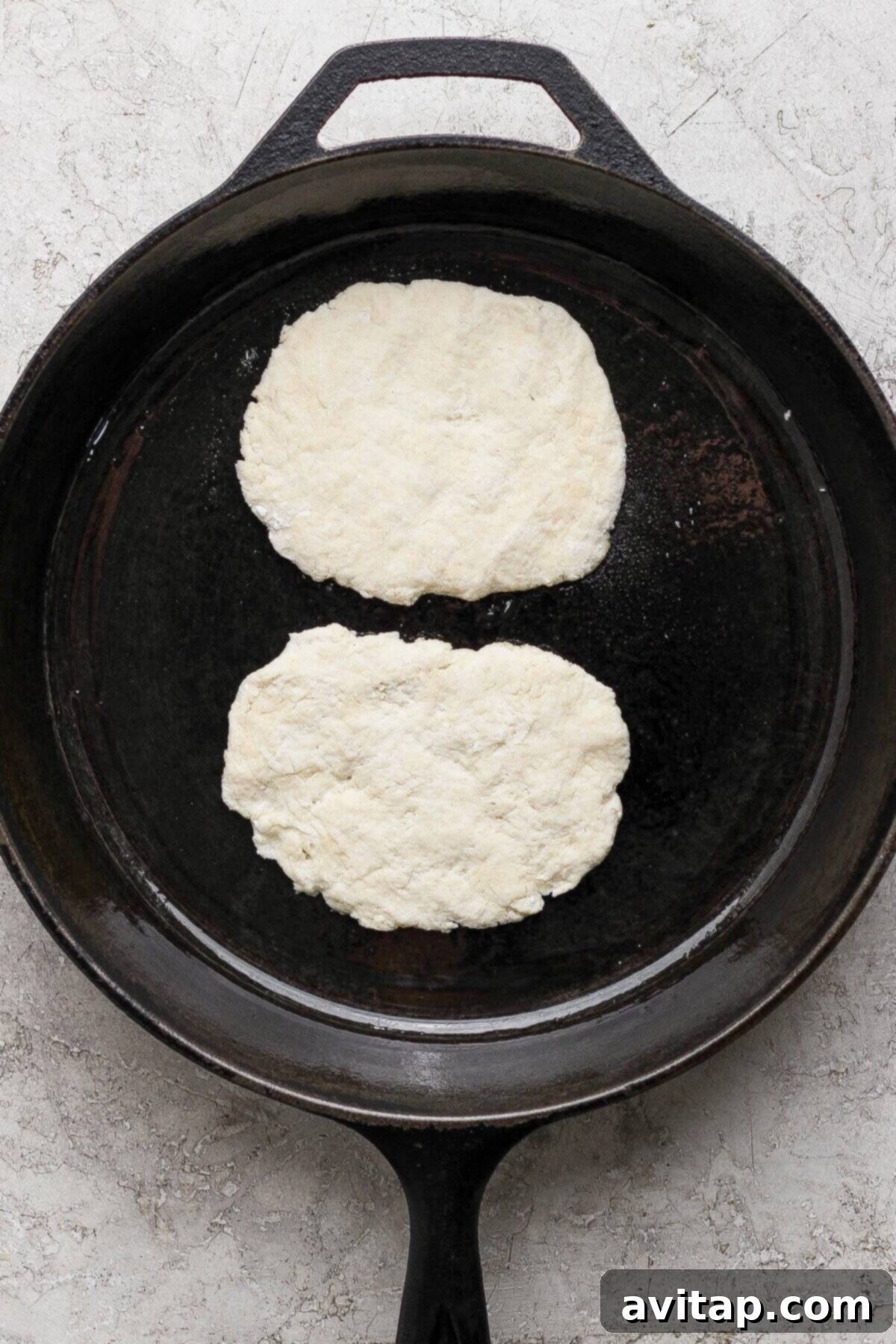 Cooking garlic naan in a skillet