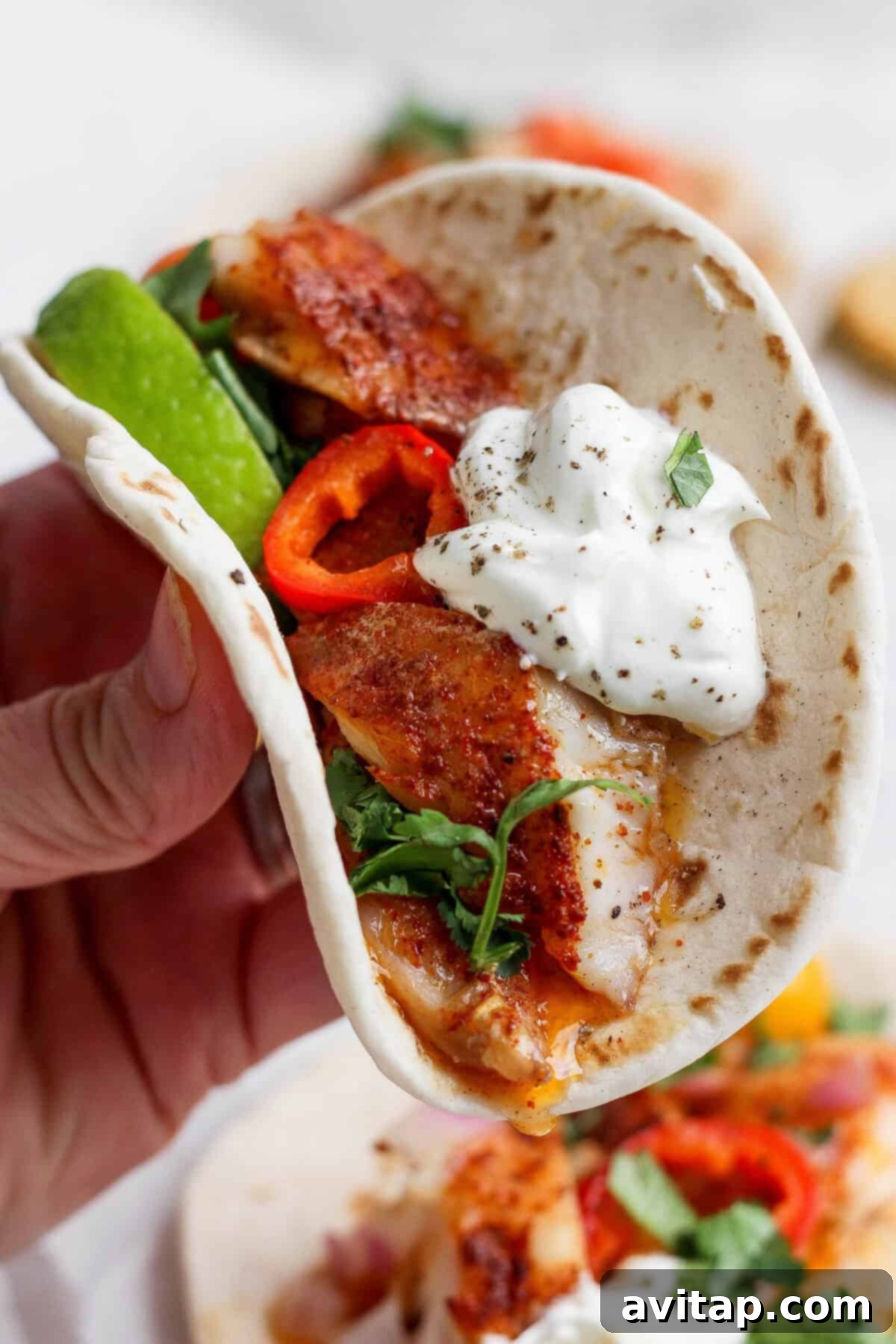 A close-up shot of a delicious and fully loaded fish taco.