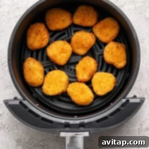 The air fryer with nuggets inside.
