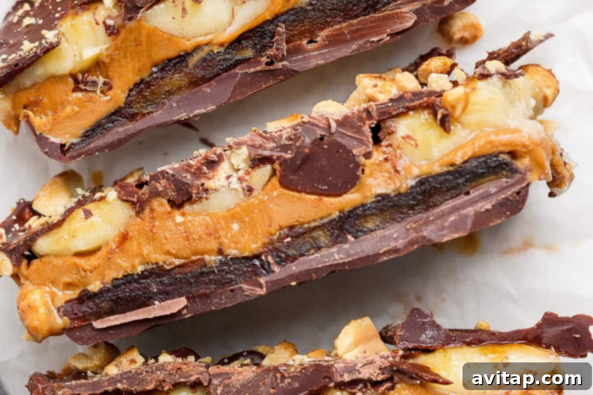 Close-up of Chunky Monkey Date Bark with visible layers of chocolate, dates, peanut butter, and peanuts.