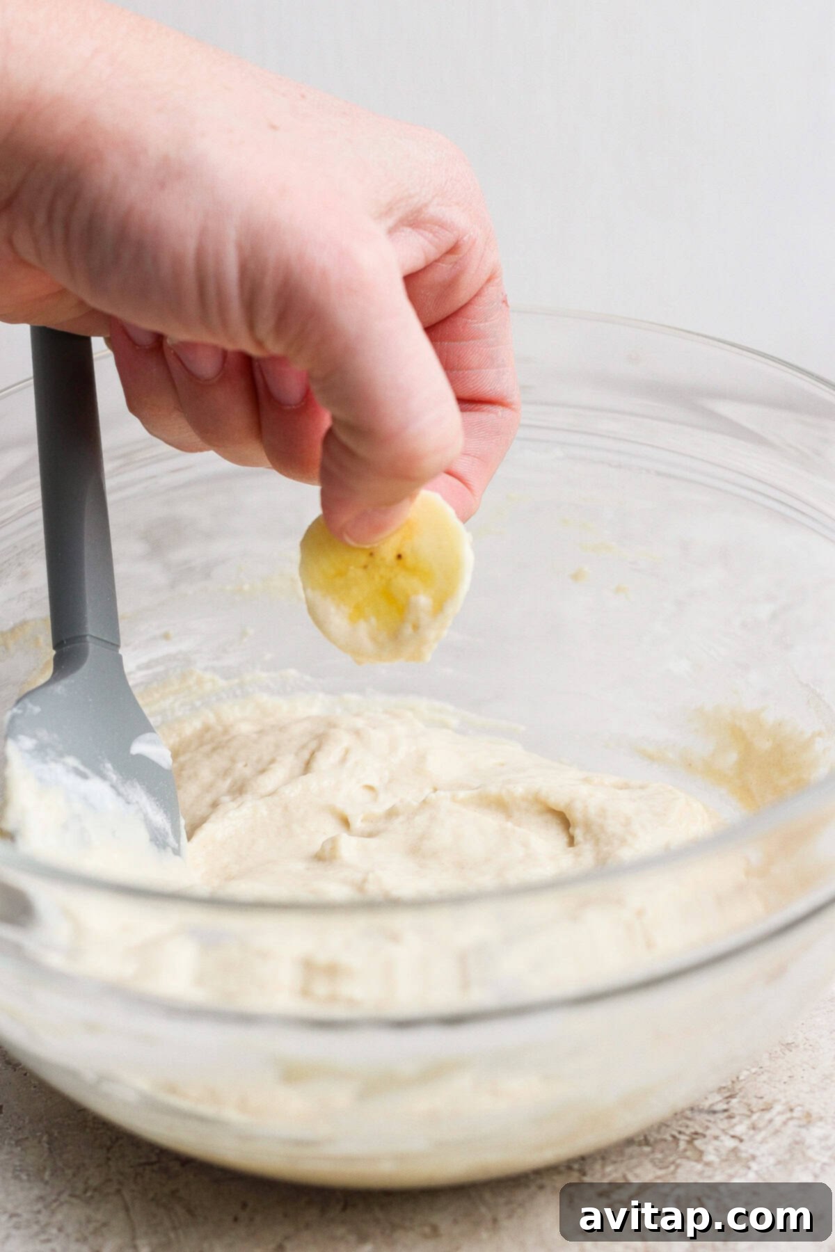 Adding a banana slice to pancake batter