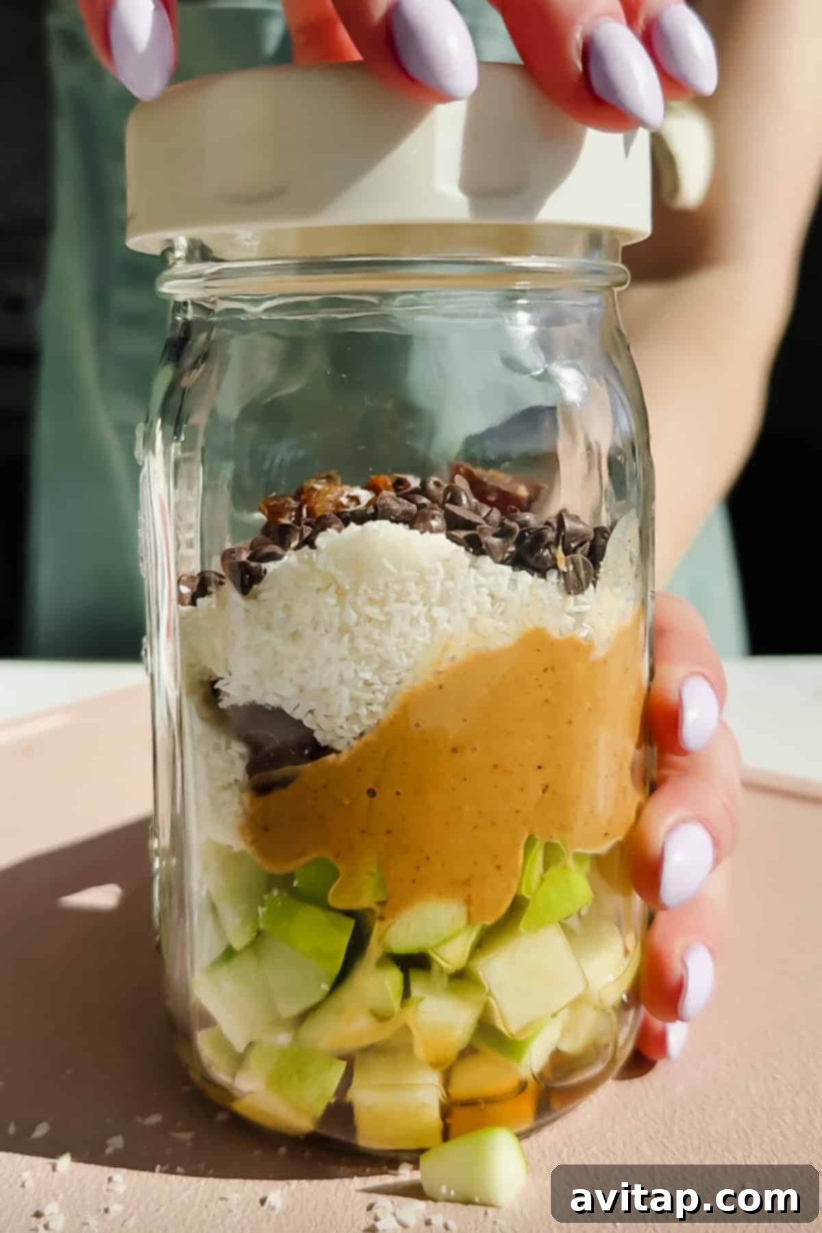 Ingredients for Caramel deLites Apple Salad in a glass jar.