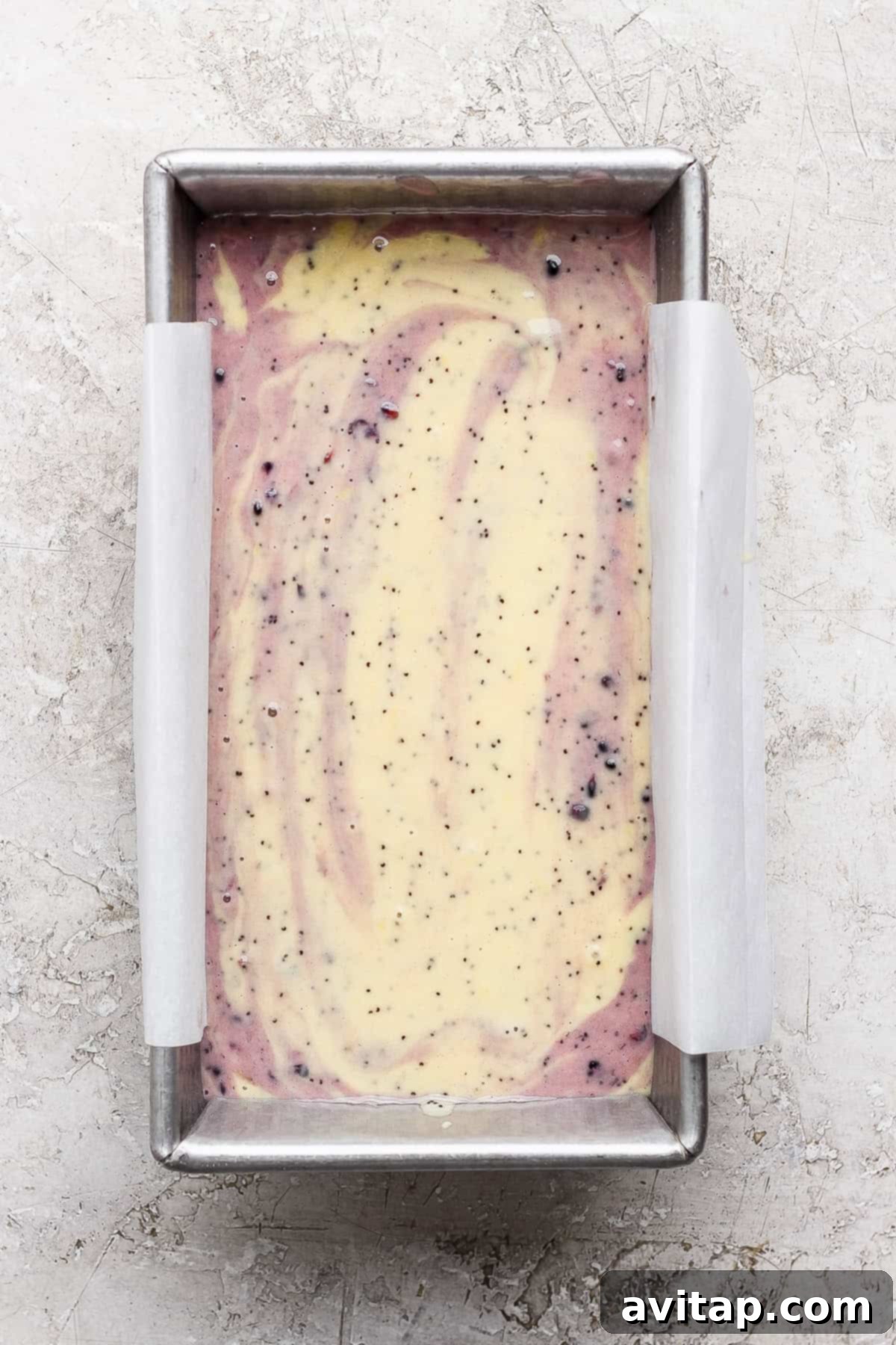 Swirled batter in parchment-lined loaf pan