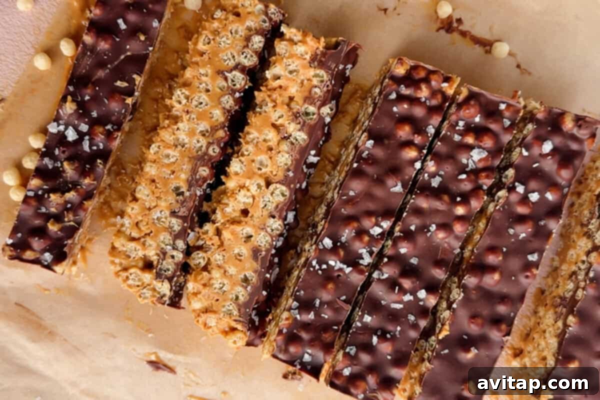 Delicious Peanut Butter Chocolate Puff Bars arranged on parchment paper with a sprinkle of sea salt.