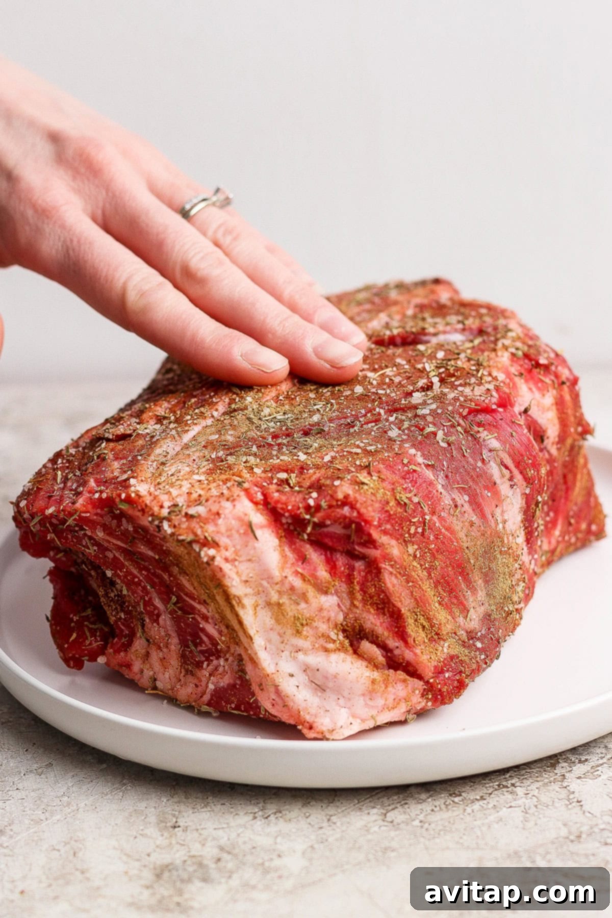 Seasoning chuck roast with spices