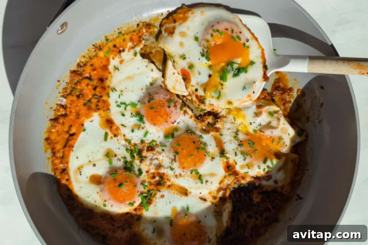Perfectly fried eggs with a creamy sauce and herbs.