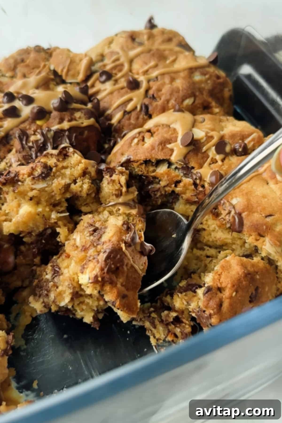 Close-up of a scoopable cookie dessert with glaze, ready to be enjoyed.