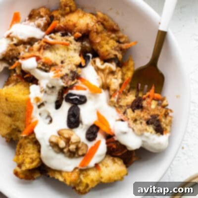 A hearty and comforting bowl of carrot cake French toast casserole, baked to golden perfection and ready to be served for a delicious brunch.