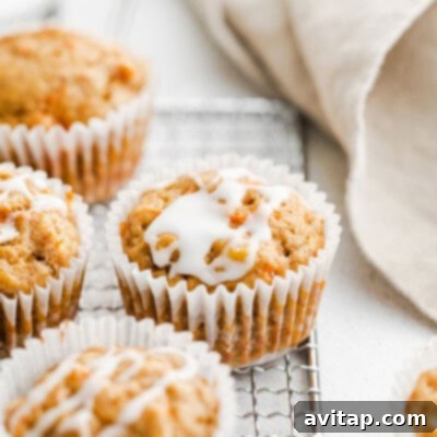 Freshly baked whole grain carrot cake muffins cooling on a wire rack, promising a wholesome and delicious treat for any time of day.