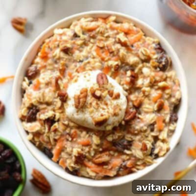 A comforting bowl of carrot cake-inspired oatmeal, generously topped with a dollop of whipped cream, inviting you to enjoy a wholesome and flavorful breakfast.