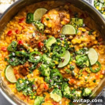 Game Changing Street Corn Recipes 5 A skillet filled with creamy stovetop street corn chicken, peppers, and onions.
