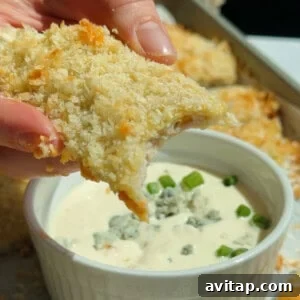 Buffalo Chicken Protein Bars — Crispy Baked Snackable Bars 15 Dipping a crispy chicken protein bar into blue cheese dressing topped with crumbled cheese and green onions