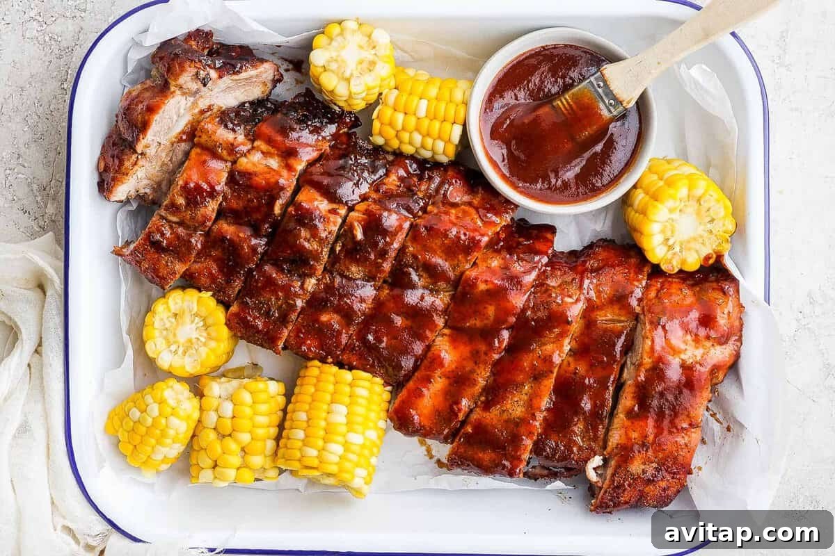 Grilled ribs and corn with bbq sauce.