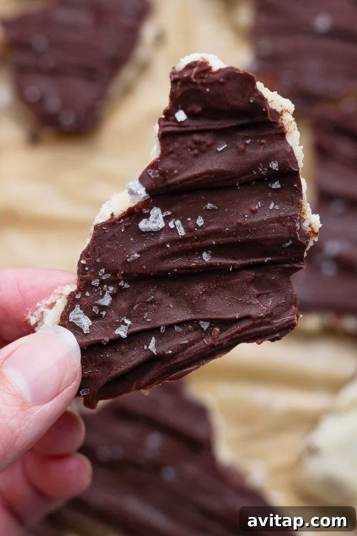 hand holding a piece of cottage cheese cookie dough bark with sea salt