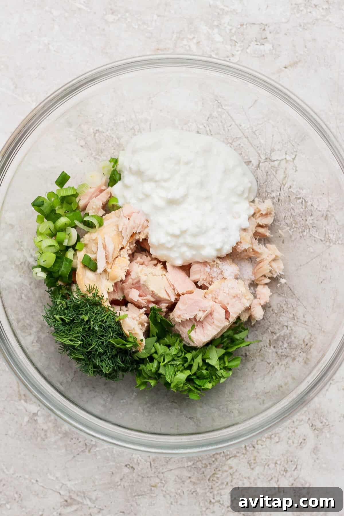 tuna cottage cheese and fresh herbs in mixing bowl