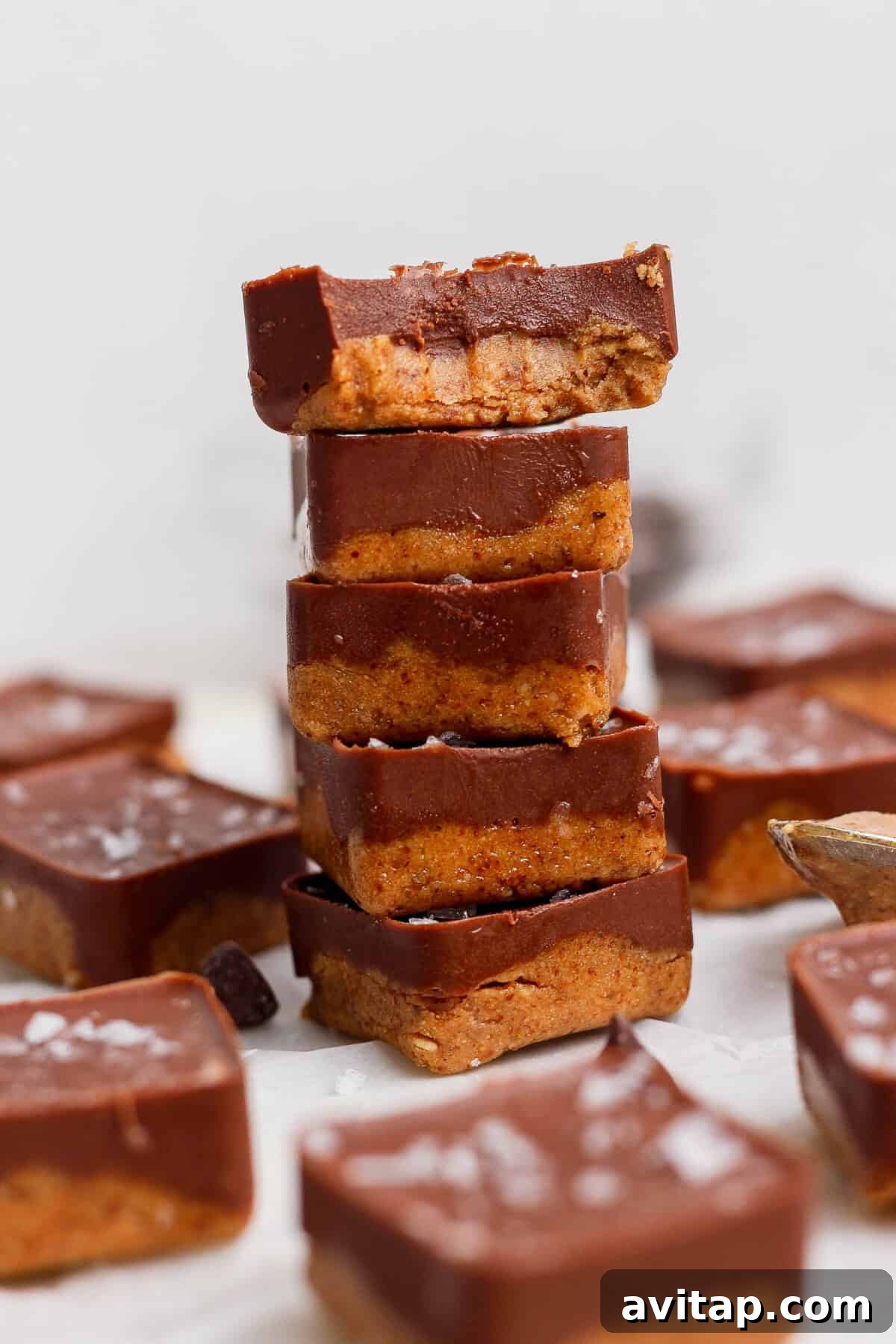 stacked thin mint protein bites with a bite taken out showing fudgy interior texture