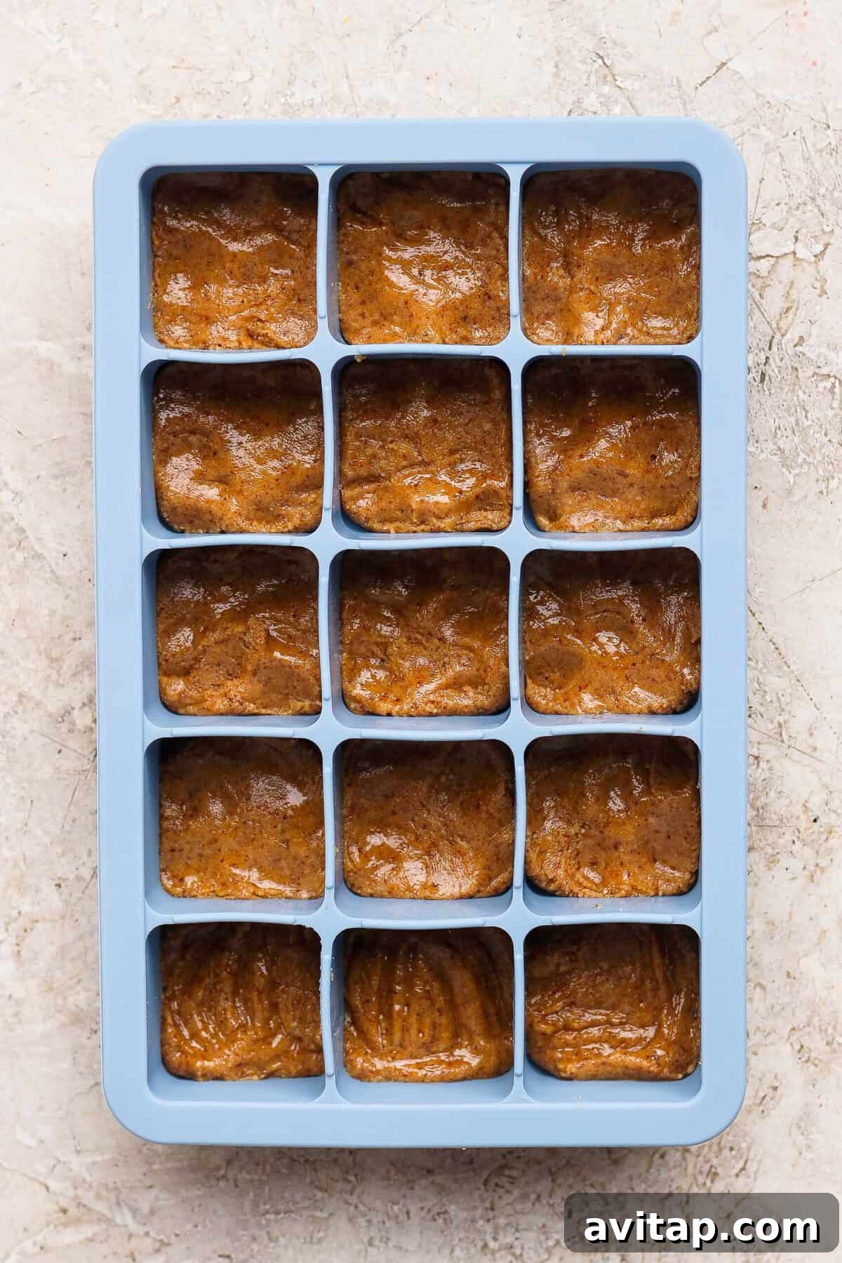 thin mint protein bite base pressed flat into a blue silicone ice cube tray