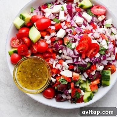 Greek salad recipe with tomatoes, cucumbers, and onions.